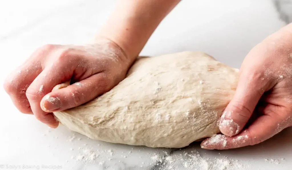 a person kneeding dough
